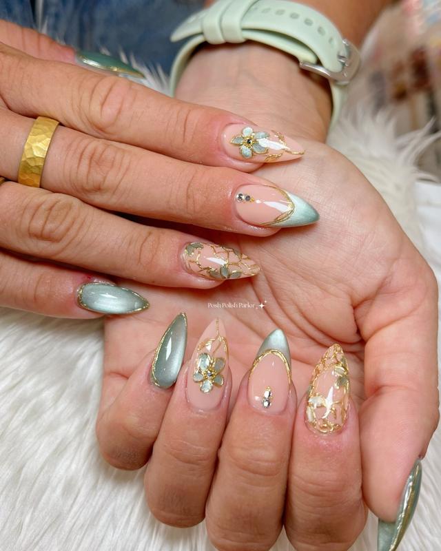 Almond nails in sage cat eye with gold-outlined flowers